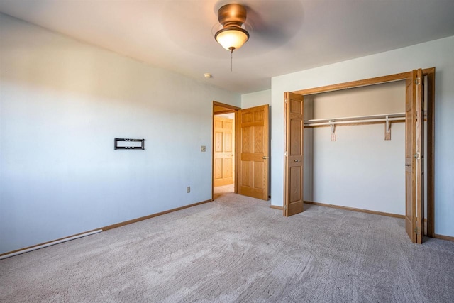 unfurnished bedroom with a closet, ceiling fan, baseboards, and carpet floors