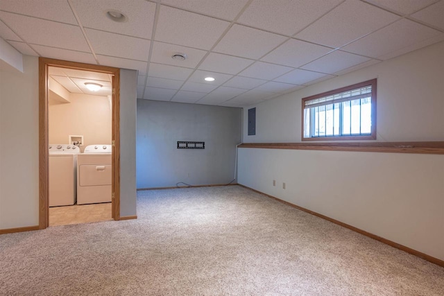 below grade area featuring baseboards, electric panel, carpet flooring, independent washer and dryer, and a drop ceiling
