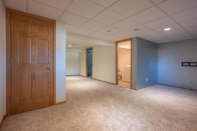 unfurnished room with carpet, washer / dryer, baseboards, and a paneled ceiling