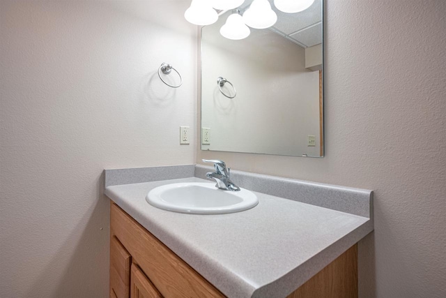 bathroom with a chandelier and vanity