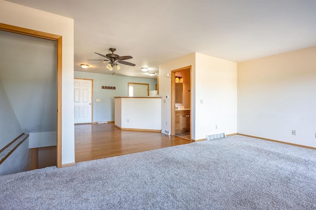 spare room with visible vents, baseboards, a ceiling fan, and carpet floors