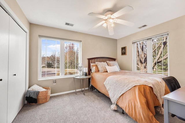 bedroom with ceiling fan, a closet, carpet flooring, and visible vents