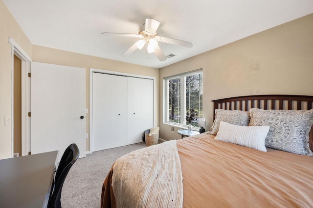 bedroom with carpet floors, ceiling fan, visible vents, and a closet