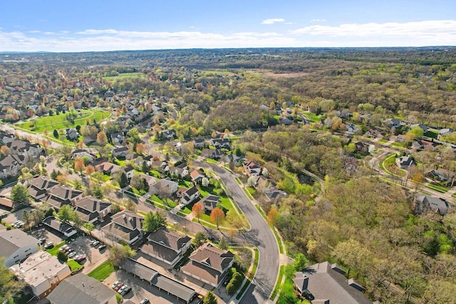 birds eye view of property featuring a residential view and a wooded view