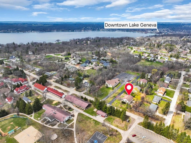 drone / aerial view with a water view and a residential view