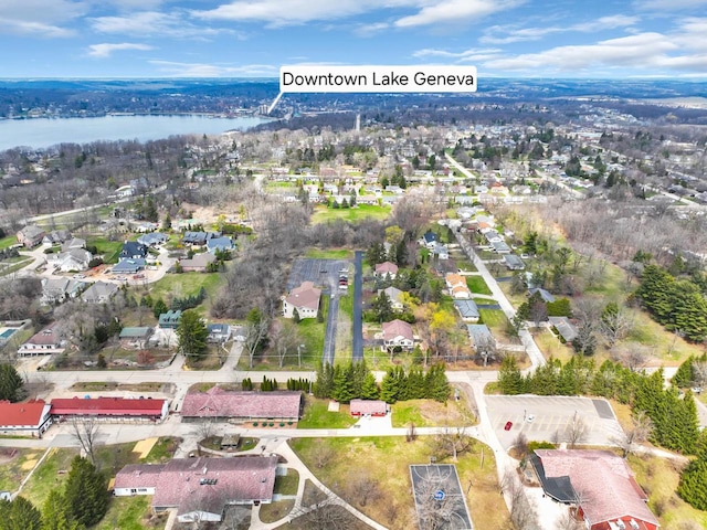 drone / aerial view featuring a residential view and a water view