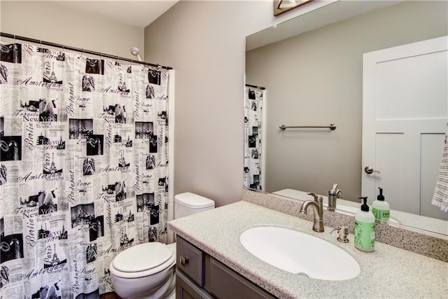 full bathroom with toilet, curtained shower, and vanity