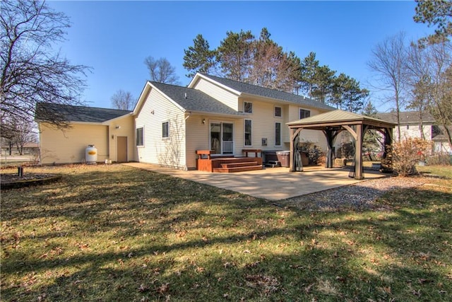 rear view of house featuring a patio, a gazebo, and a lawn