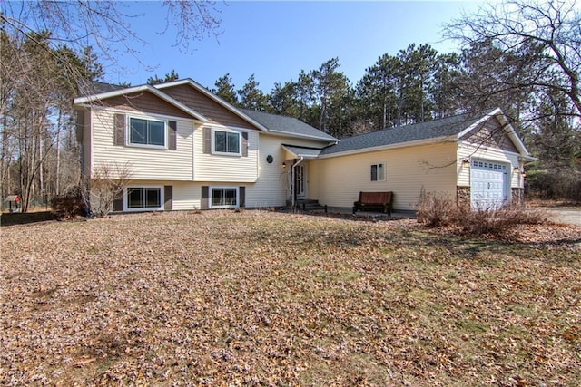 tri-level home featuring entry steps and an attached garage