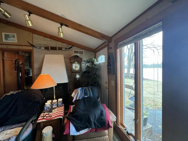 1487 Gunlock Shores Ln, Minocqua, WI 54548 - interior space featuring lofted ceiling with beams, visible vents, and rail lighting