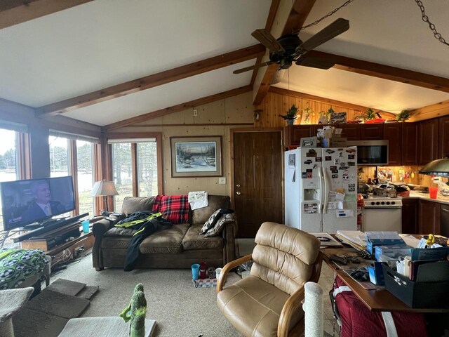 1487 Gunlock Shores Ln, Minocqua, WI 54548 - living room featuring carpet floors, wood walls, a ceiling fan, and lofted ceiling with beams
