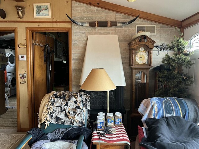 1487 Gunlock Shores Ln, Minocqua, WI 54548 - living room featuring vaulted ceiling, visible vents, and stacked washer / dryer