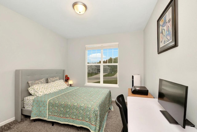 bedroom with baseboards and carpet