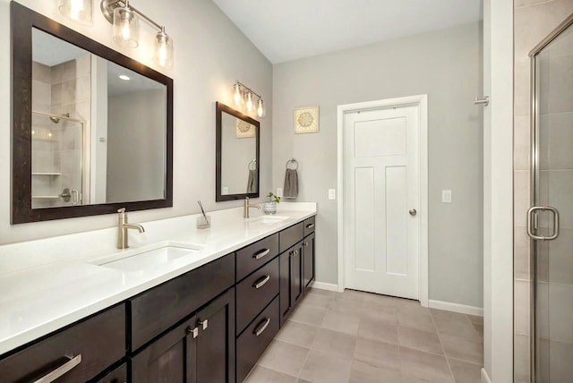 bathroom featuring a stall shower, double vanity, and a sink