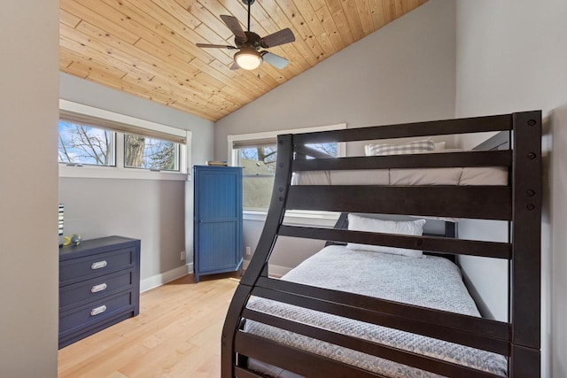 bedroom with ceiling fan, vaulted ceiling, wooden ceiling, light wood finished floors, and baseboards