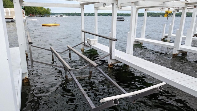 dock area with a water view and boat lift