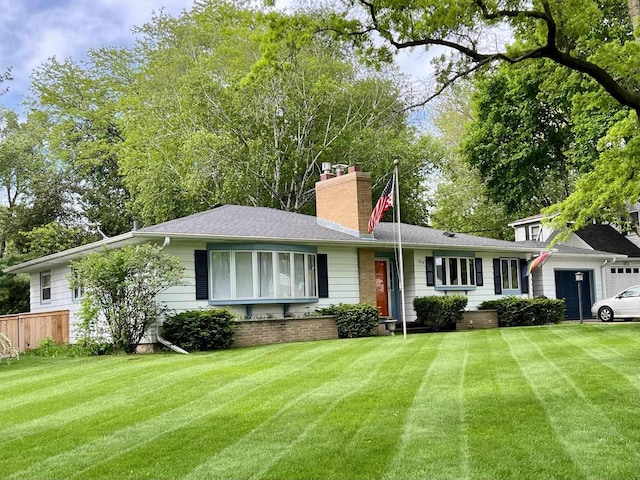 single story home featuring a chimney, fence, a front yard, and an attached garage