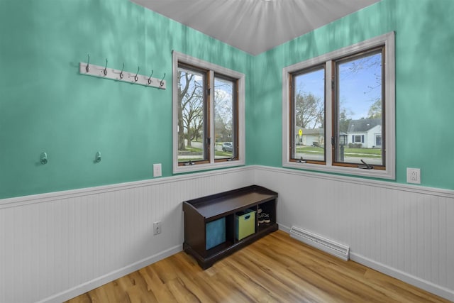 interior space featuring a wainscoted wall, visible vents, wood finished floors, and a healthy amount of sunlight