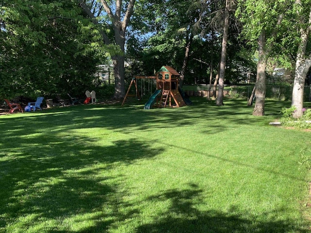 view of yard featuring fence and a playground
