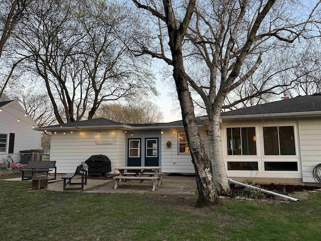 back of house with a lawn and a patio area