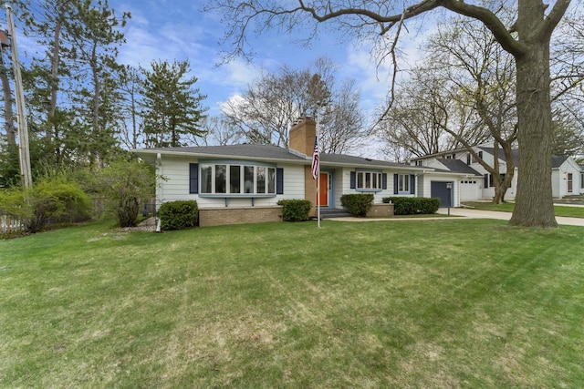 single story home with a chimney, a front yard, driveway, and an attached garage