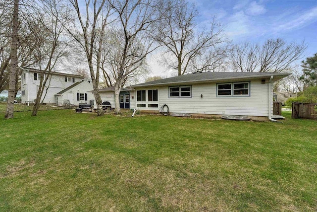 back of property featuring a yard