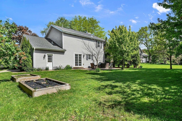 2 Oak Glen Ct, Madison, WI 53717 - rear view of property with a vegetable garden, a lawn, and a patio area