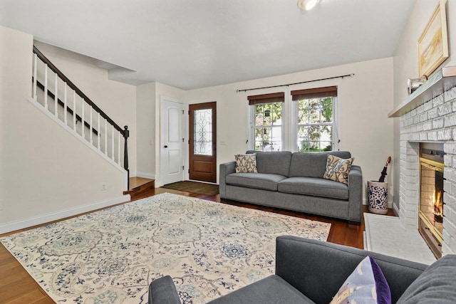 2 Oak Glen Ct, Madison, WI 53717 - living room featuring stairway, a brick fireplace, dark wood-style flooring, and baseboards