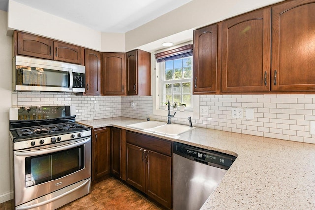 2 Oak Glen Ct, Madison, WI 53717 - kitchen featuring stainless steel appliances, a sink, light stone counters, and backsplash