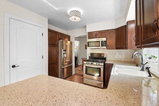 2 Oak Glen Ct, Madison, WI 53717 - kitchen with appliances with stainless steel finishes, a sink, tasteful backsplash, and light stone countertops