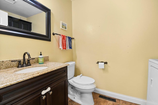 2 Oak Glen Ct, Madison, WI 53717 - half bathroom with toilet, vanity, baseboards, and washer / dryer