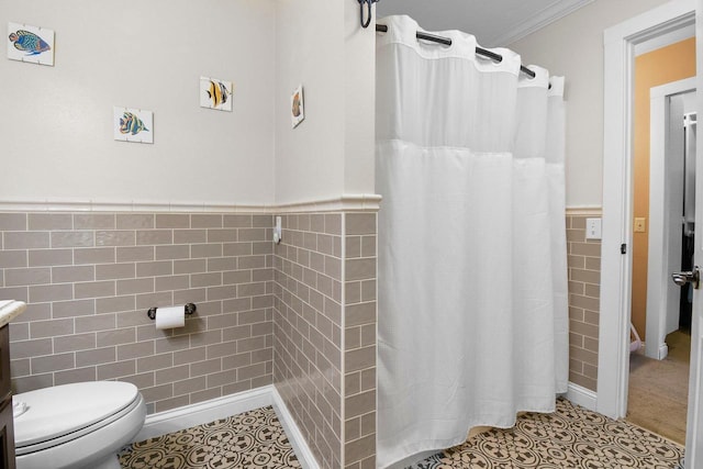 2 Oak Glen Ct, Madison, WI 53717 - bathroom featuring tile walls, tile patterned floors, toilet, a shower with shower curtain, and a wainscoted wall