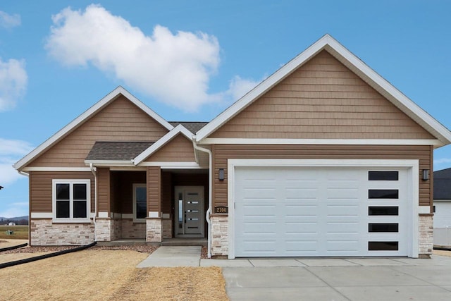 2020 Mulberry St, Sauk City, WI 53583 - view of front of home with concrete driveway, roof with shingles, stone siding, and a garage