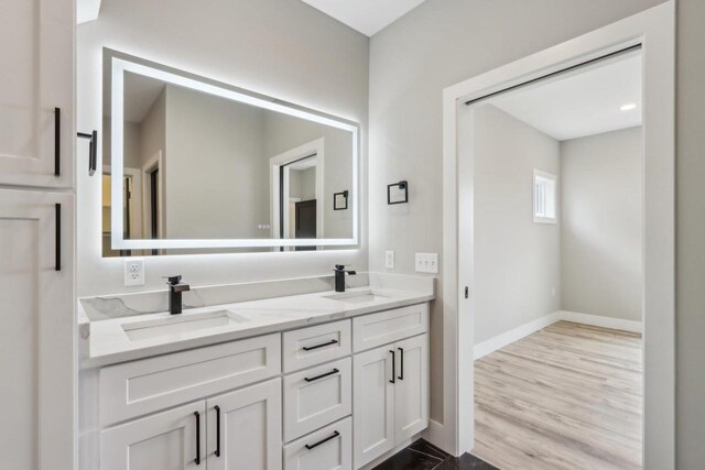 2020 Mulberry St, Sauk City, WI 53583 - bathroom featuring a sink, baseboards, and double vanity