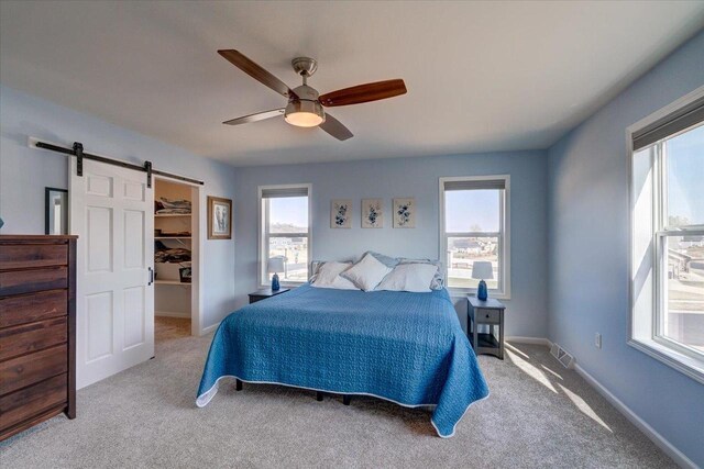 4062 Red Hawk Run, Black Earth, WI 53515 - bedroom with multiple windows, visible vents, and a barn door