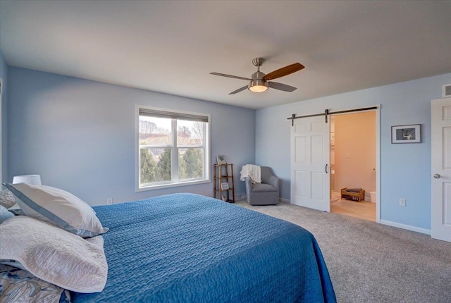 4062 Red Hawk Run, Black Earth, WI 53515 - bedroom featuring ceiling fan, ensuite bath, a barn door, carpet flooring, and baseboards