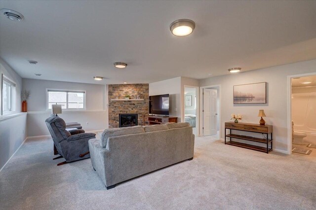 4062 Red Hawk Run, Black Earth, WI 53515 - living room with a large fireplace, visible vents, baseboards, and light colored carpet