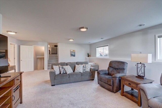 4062 Red Hawk Run, Black Earth, WI 53515 - living room featuring light carpet and stairs