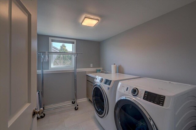 4062 Red Hawk Run, Black Earth, WI 53515 - laundry room with independent washer and dryer, light tile patterned flooring, a sink, baseboards, and cabinet space