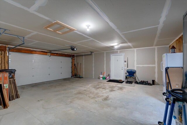 4062 Red Hawk Run, Black Earth, WI 53515 - garage with freestanding refrigerator and a garage door opener
