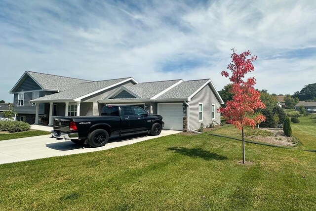 4062 Red Hawk Run, Black Earth, WI 53515 - view of side of property featuring an attached garage, a shingled roof, concrete driveway, and a lawn