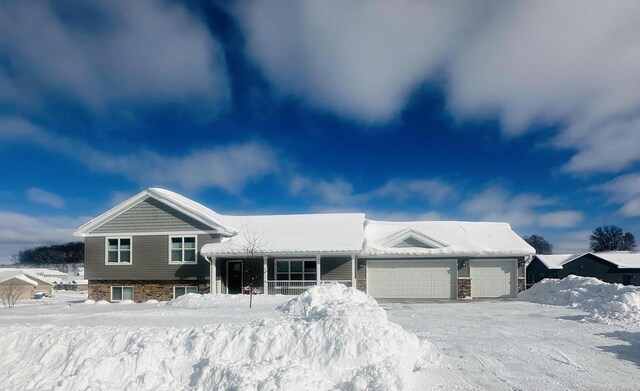 4062 Red Hawk Run, Black Earth, WI 53515 - tri-level home featuring stone siding and a garage