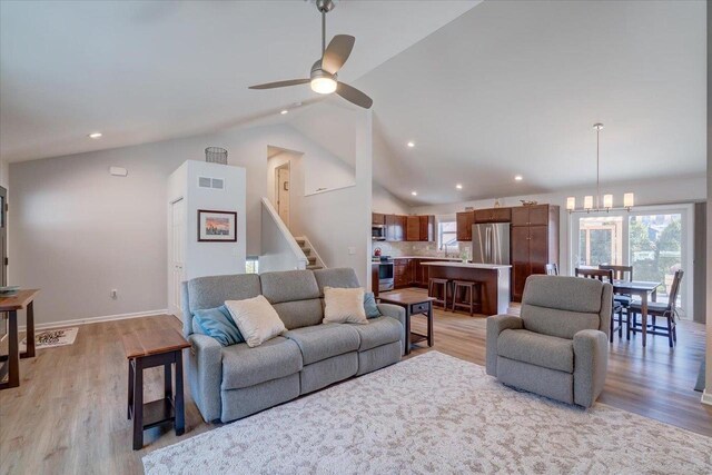 4062 Red Hawk Run, Black Earth, WI 53515 - living area with light wood-style flooring, visible vents, a ceiling fan, and lofted ceiling