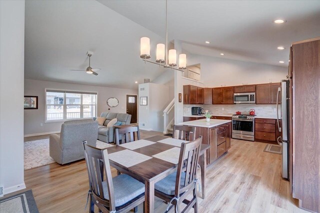 4062 Red Hawk Run, Black Earth, WI 53515 - dining area featuring high vaulted ceiling, stairs, light wood-type flooring, and ceiling fan