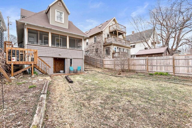 1015 E Johnson St, Madison, WI 53703 - back of house featuring a sunroom, roof with shingles, fence, and stairway