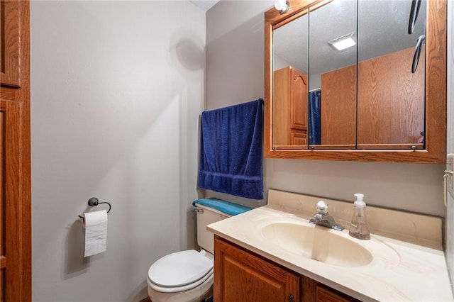 bathroom featuring toilet and vanity