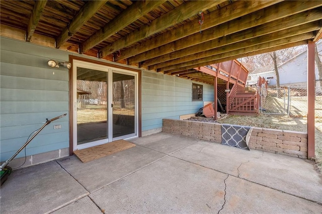 view of patio / terrace featuring stairs and a gate