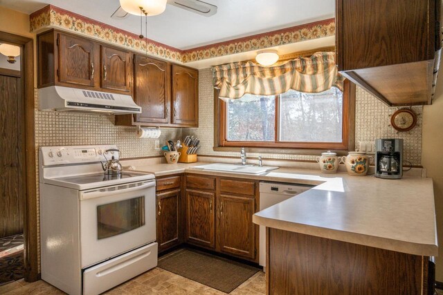 W5384 25th St, Necedah, WI 54646 - kitchen with tasteful backsplash, white appliances, light countertops, extractor fan, and a sink