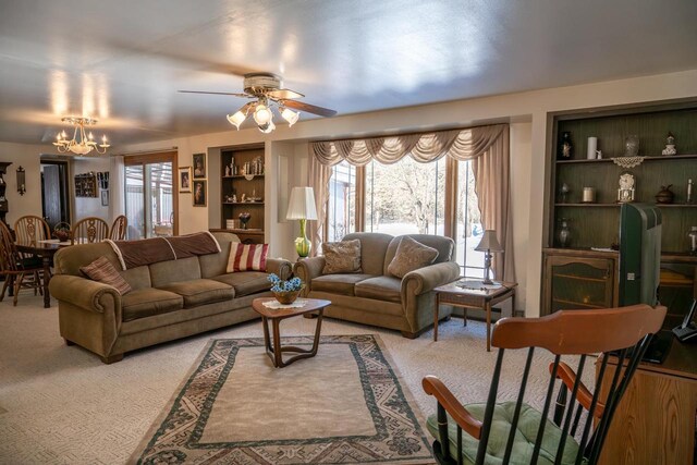 W5384 25th St, Necedah, WI 54646 - living room with light carpet, ceiling fan with notable chandelier, and built in features