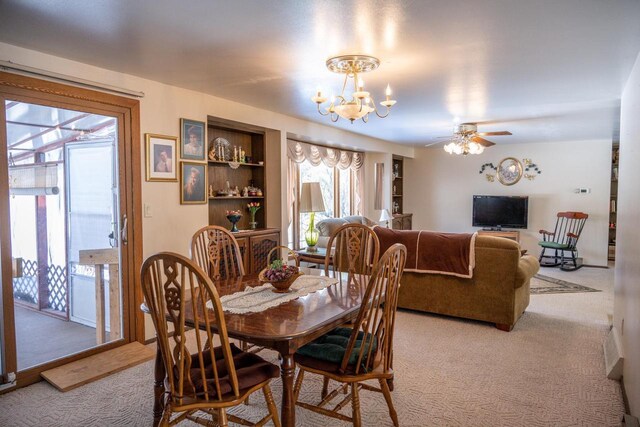 W5384 25th St, Necedah, WI 54646 - dining area featuring light carpet, ceiling fan with notable chandelier, and plenty of natural light